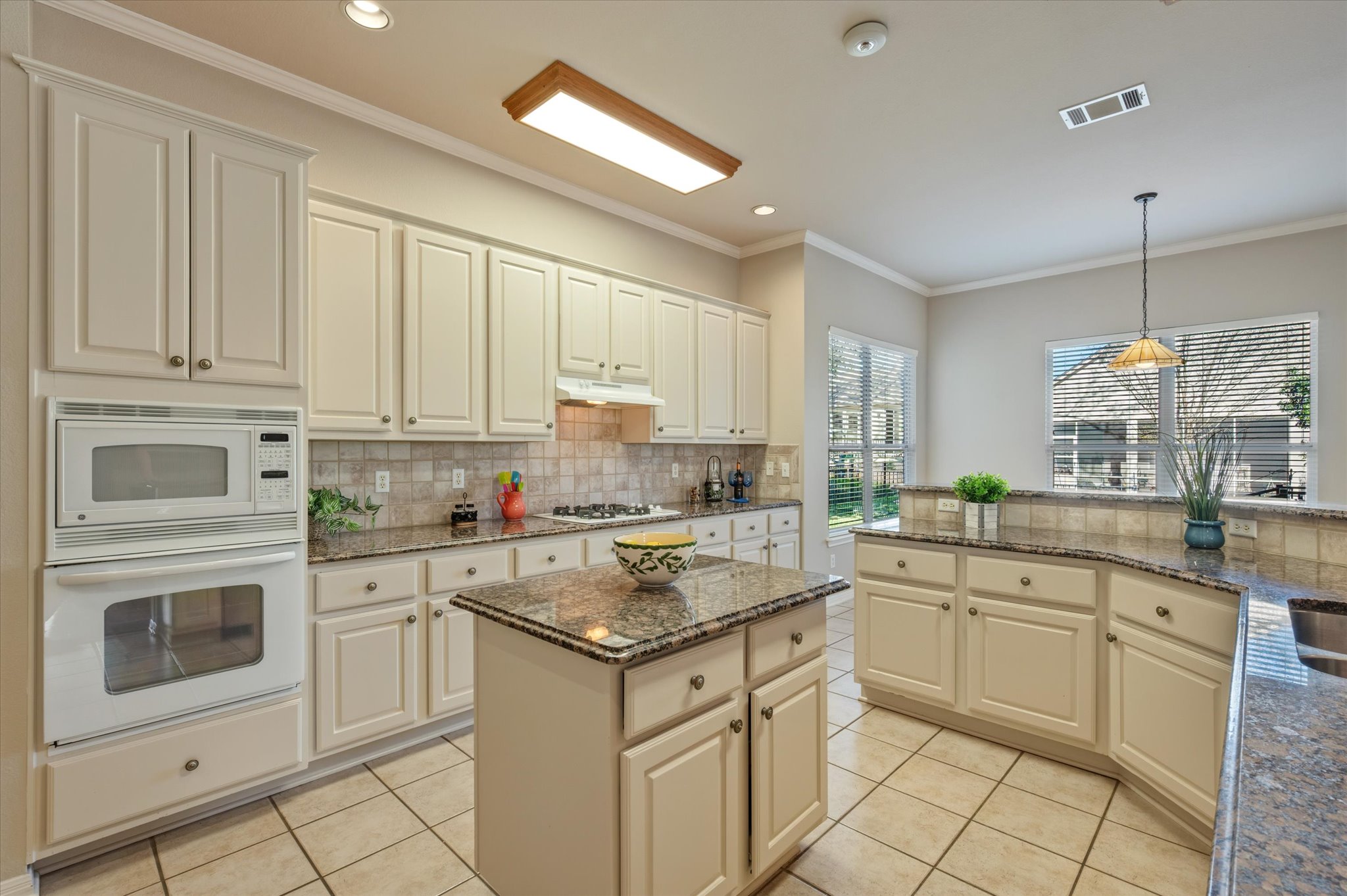 114 Whippoorwill Way Georgetown, TX 78633 - Photo 14 of 37 a kitchen with white cabinets and white appliances