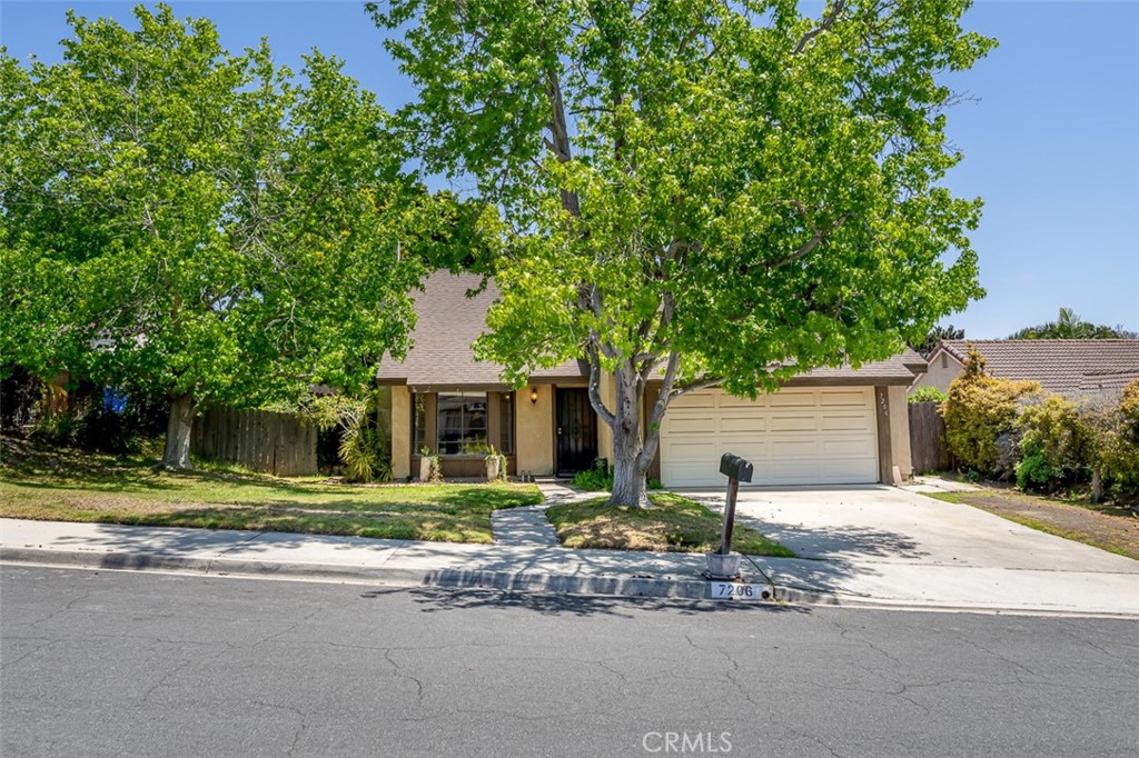 a front view of a house with a yard and a garage