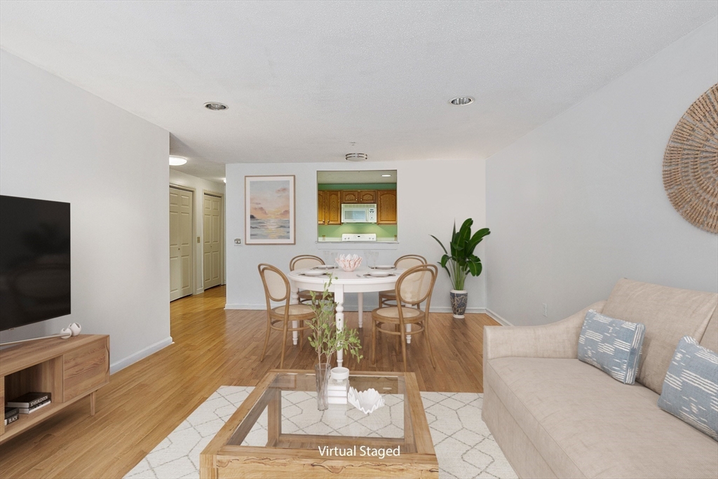 a living room with furniture a wooden floor and a flat screen tv