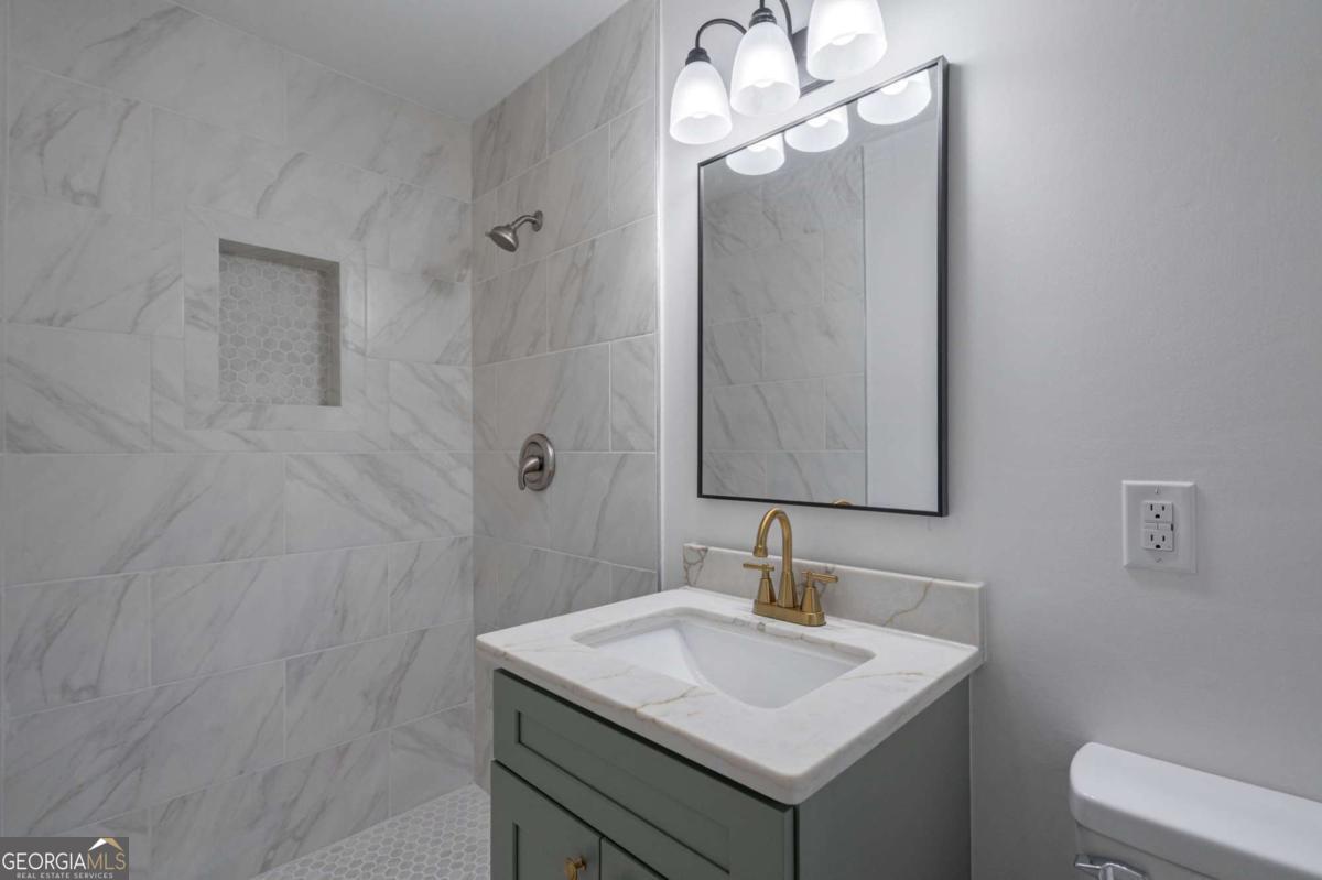 400 Sandstone Drive Athens, GA 30605 - Photo 13 of 41 a bathroom with a sink a light fixture and a toilet