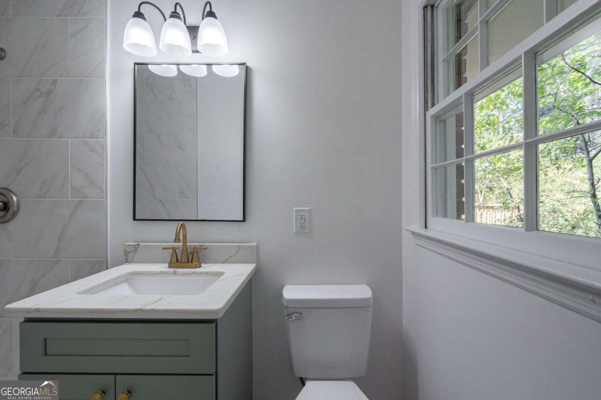 400 Sandstone Drive Athens, GA 30605 - Photo 14 of 41 a bathroom with a sink a toilet and a mirror