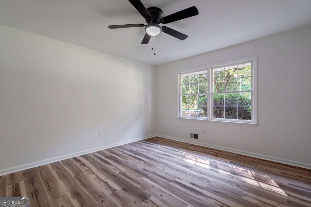 400 Sandstone Drive Athens, GA 30605 - Photo 15 of 41 a view of empty room with wooden floor and fan