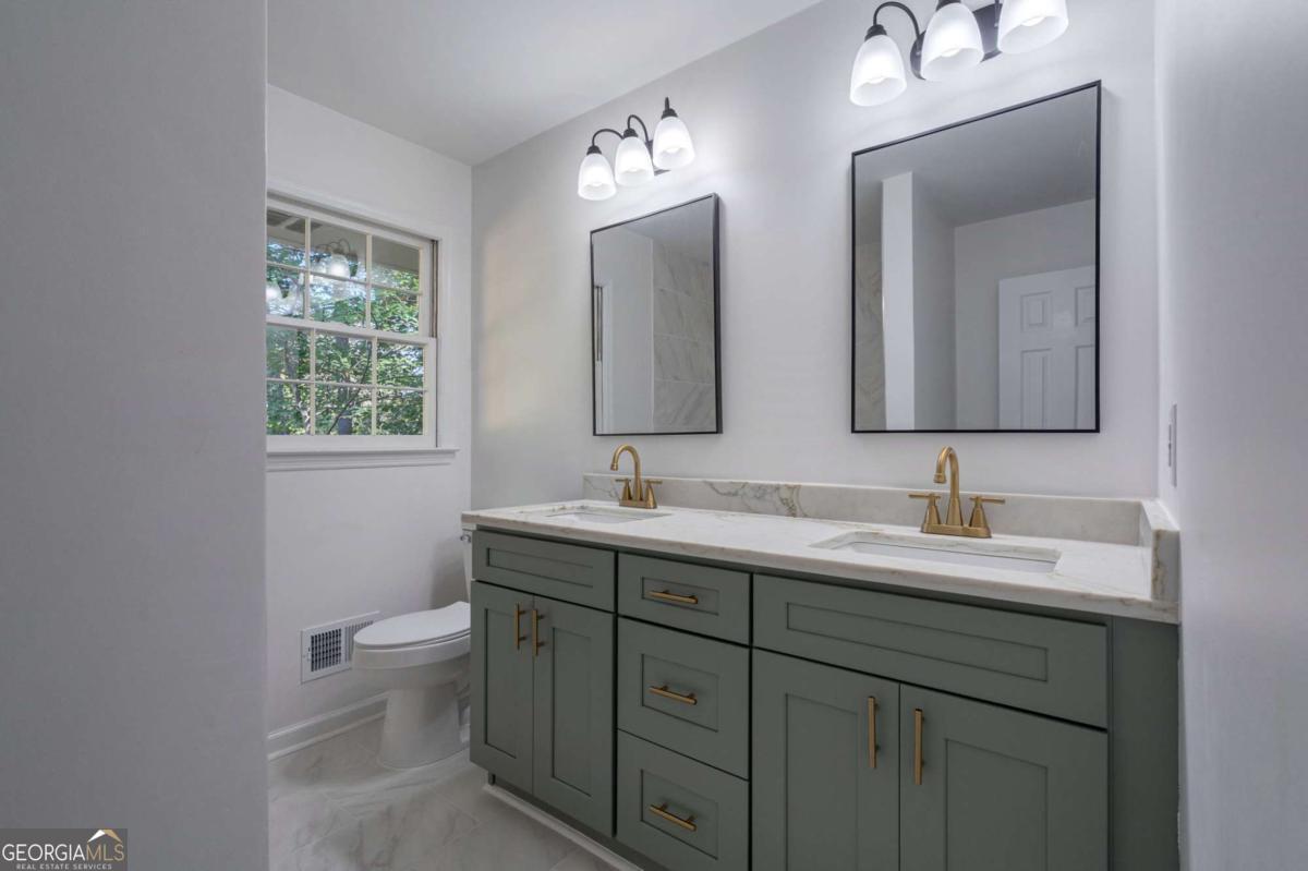400 Sandstone Drive Athens, GA 30605 - Photo 17 of 41 a bathroom with 2 sink and a mirror