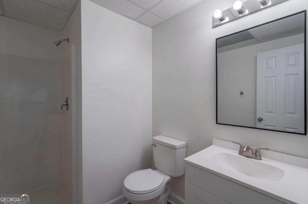 400 Sandstone Drive Athens, GA 30605 - Photo 34 of 41 a bathroom with a toilet a sink and mirror
