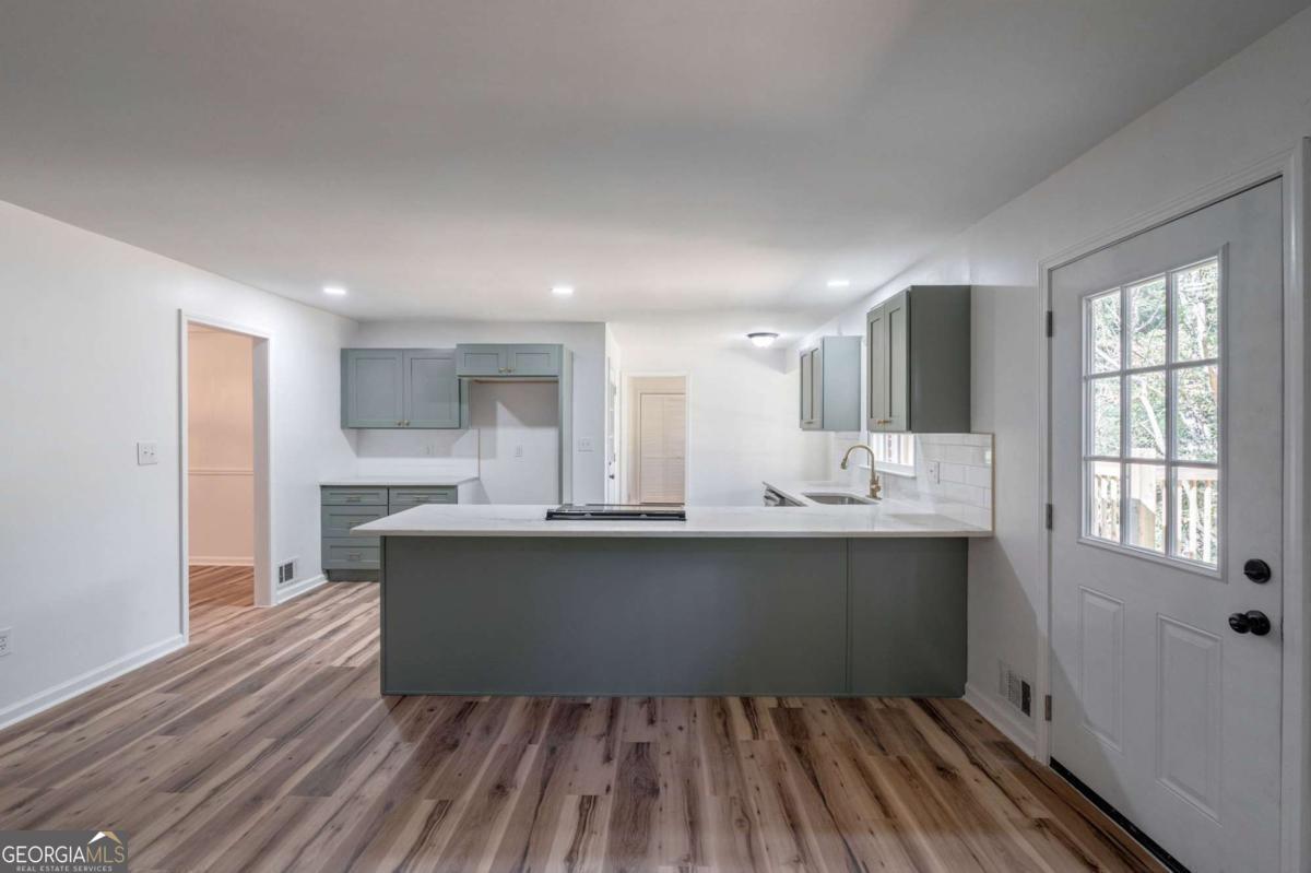 400 Sandstone Drive Athens, GA 30605 - Photo 5 of 41 a kitchen with kitchen island sink stove and cabinets