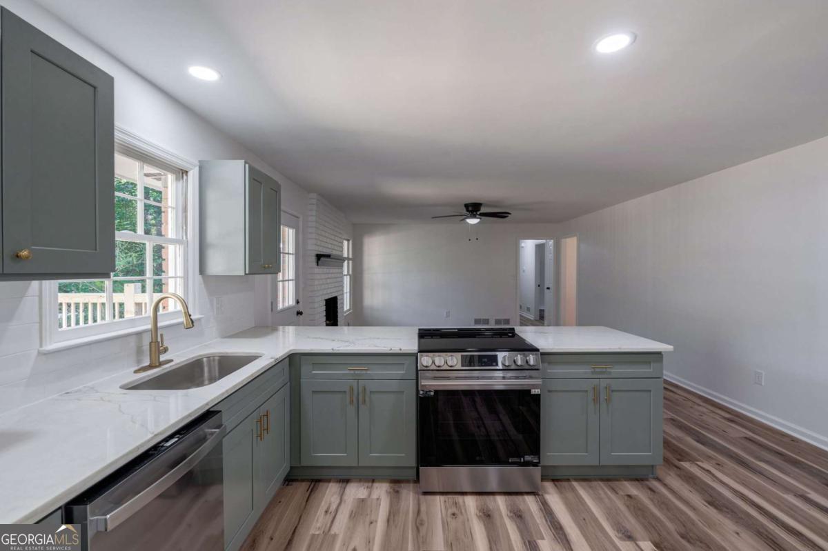 400 Sandstone Drive Athens, GA 30605 - Photo 7 of 41 a kitchen with a sink stove top oven and cabinets