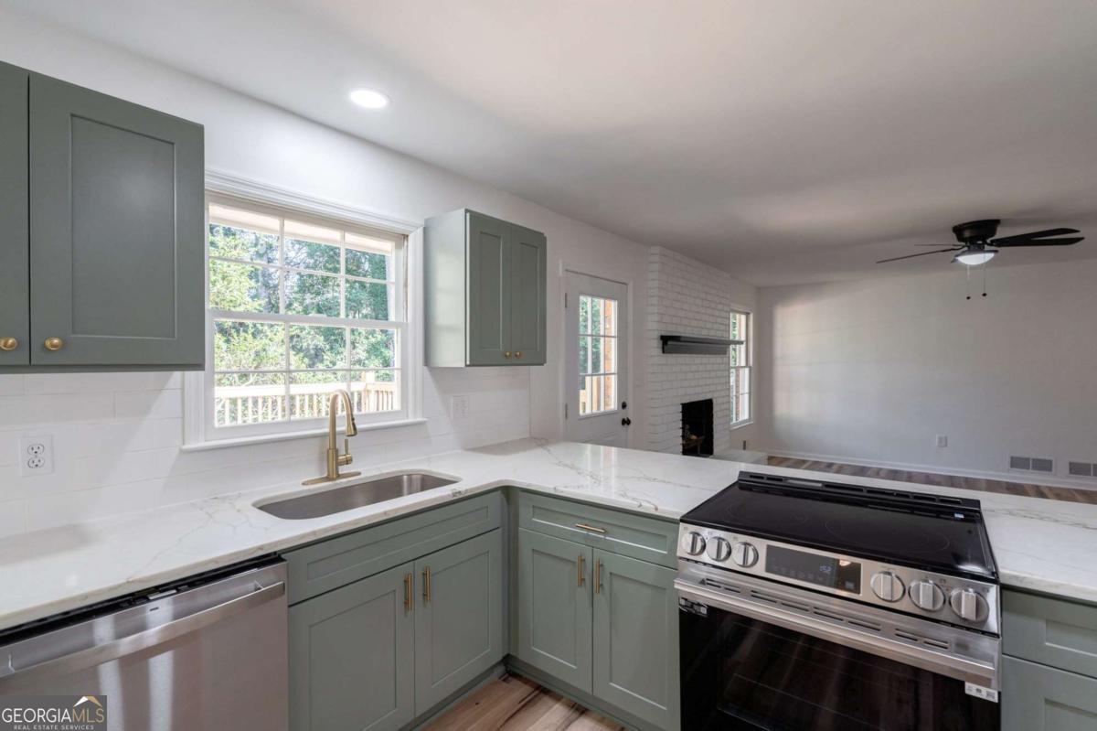 400 Sandstone Drive Athens, GA 30605 - Photo 9 of 41 a kitchen with a stove and a sink