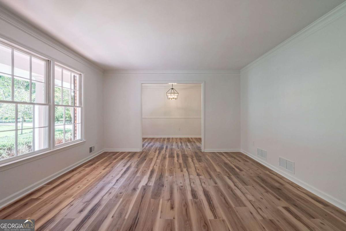 400 Sandstone Drive Athens, GA 30605 - Photo 10 of 41 a view of an empty room with wooden floor and a window