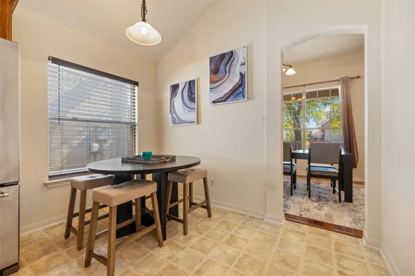 a kitchen with stainless steel appliances kitchen island granite countertop a sink a stove a refrigerator a counter top space and cabinets