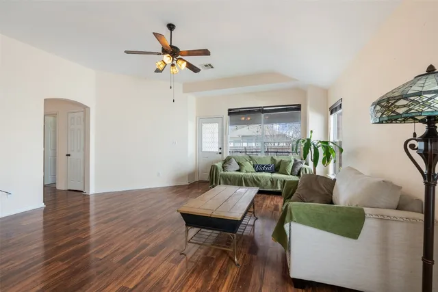 a living room with furniture and a chandelier