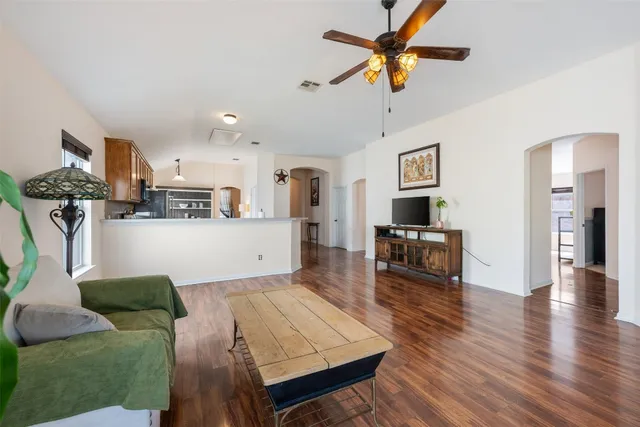 a living room with furniture and a wooden floor
