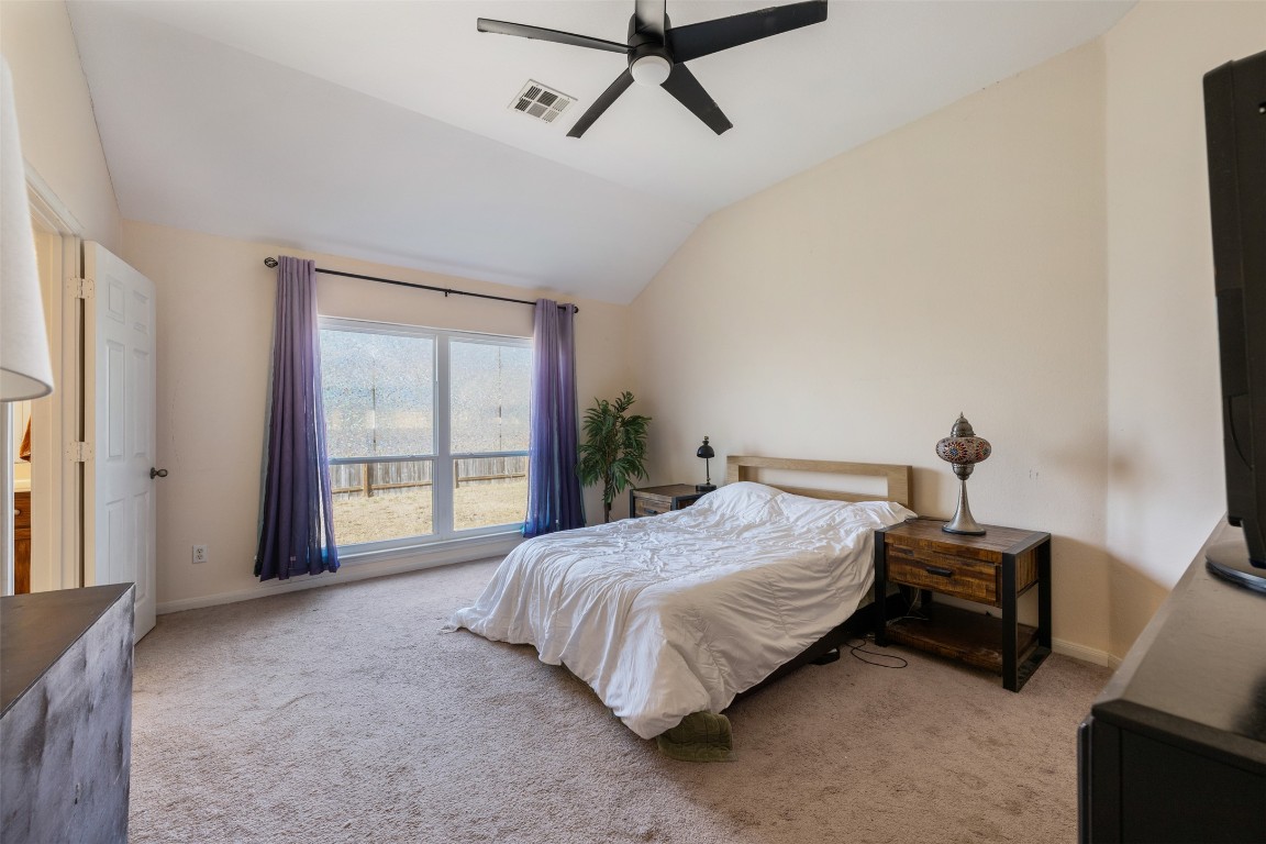 221 Stone Crest Boulevard Buda, TX 78610 - Photo 17 of 33 a bedroom with a bed and a window