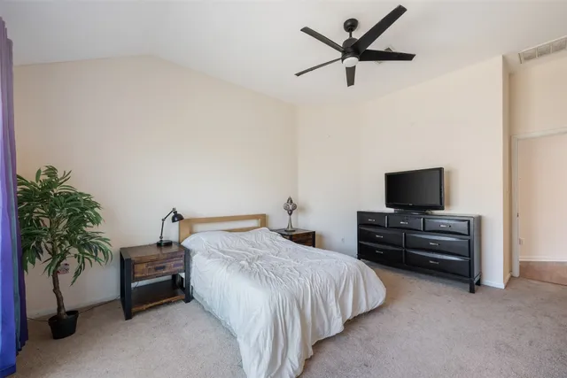 a bedroom with a bed and a television