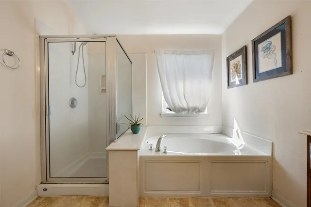 a spacious bathroom with a double vanity sink and a mirror