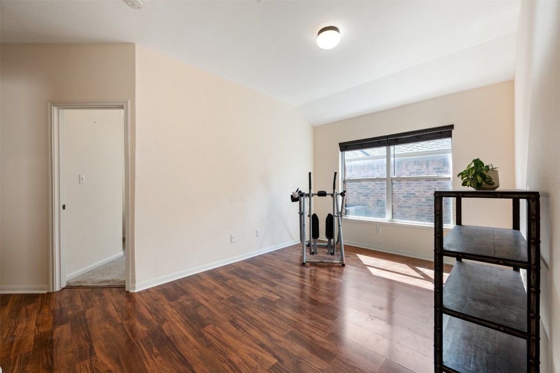 221 Stone Crest Boulevard Buda, TX 78610 - Photo 26 of 33 wooden floor in an empty room with a window