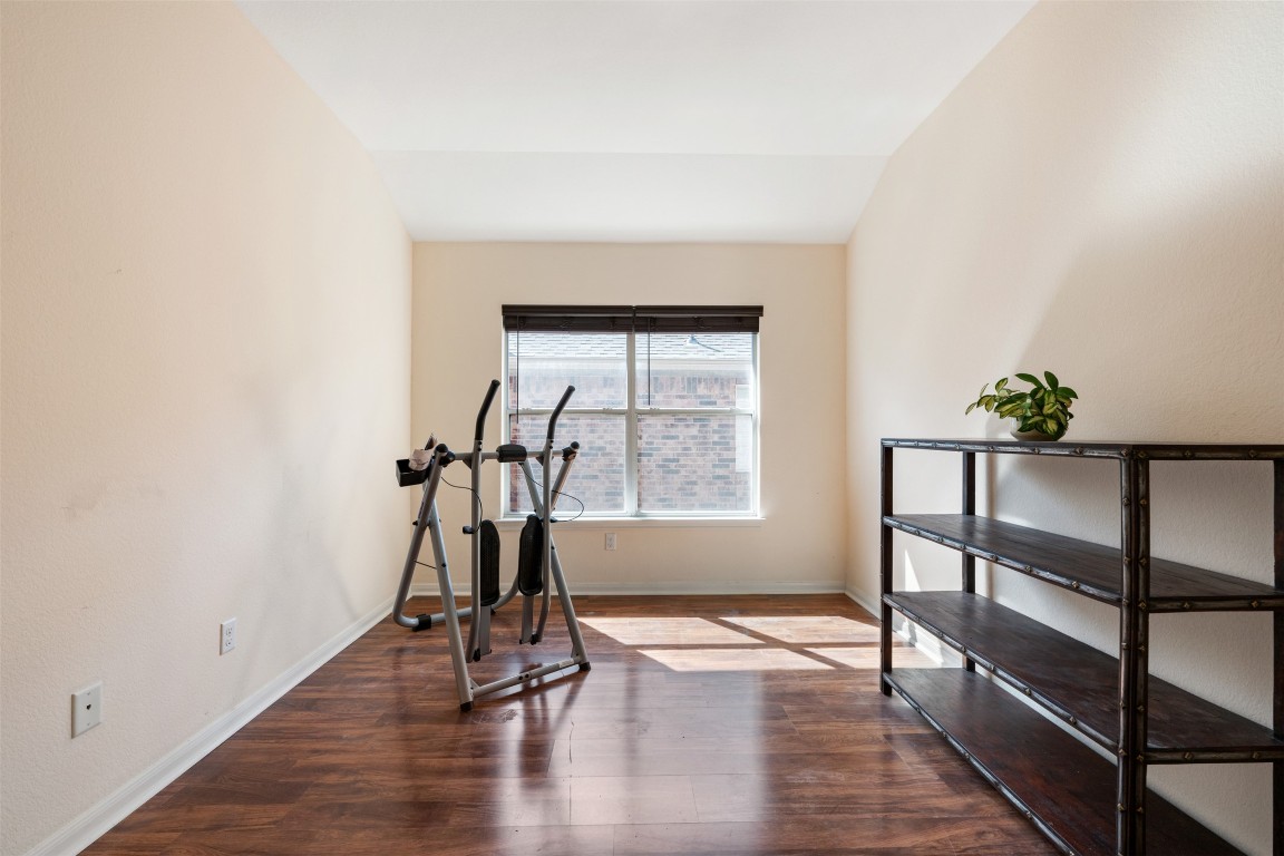 221 Stone Crest Boulevard Buda, TX 78610 - Photo 27 of 33 an empty room with wooden floor and windows