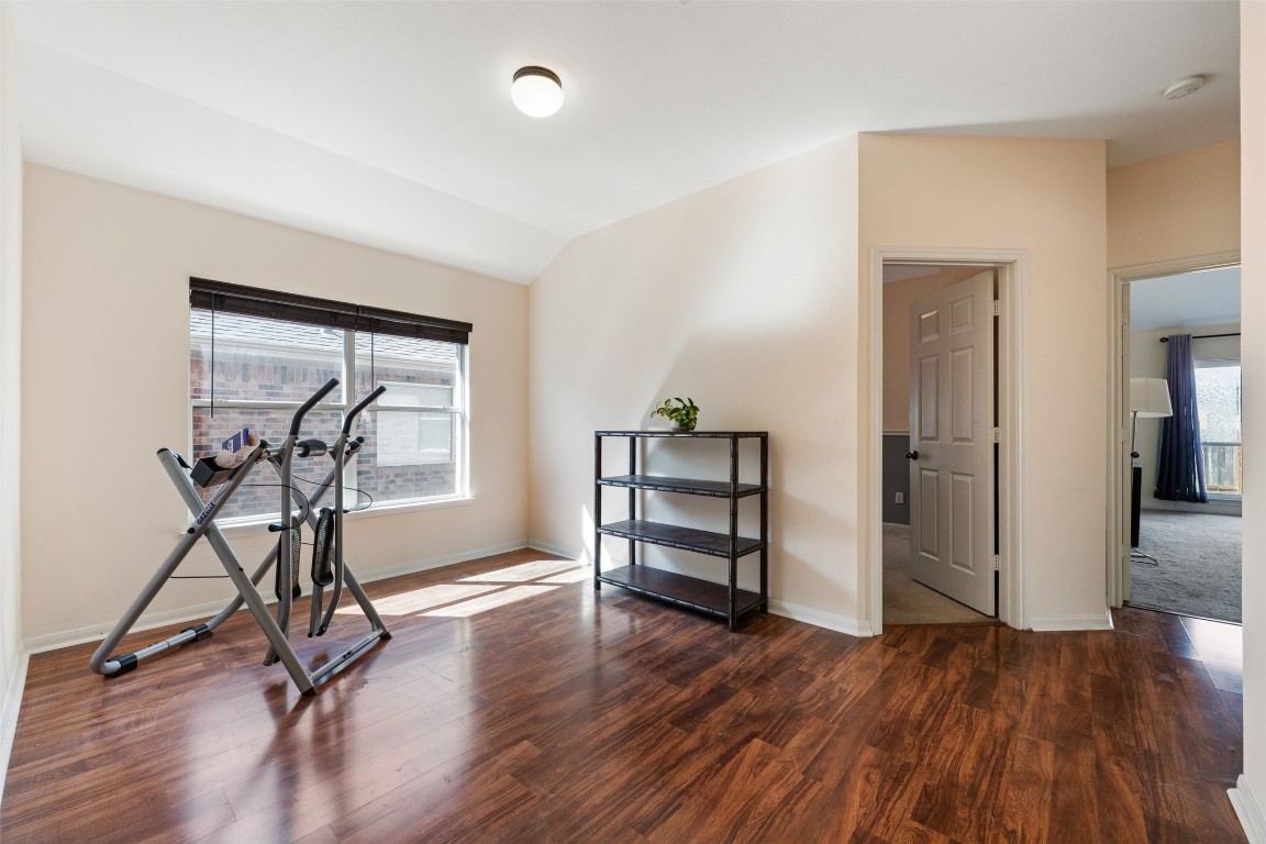 221 Stone Crest Boulevard Buda, TX 78610 - Photo 28 of 33 wooden floor and windows in a room with a workspace