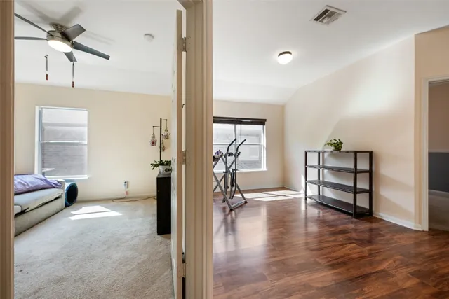 wooden floor and windows in a room with a workspace
