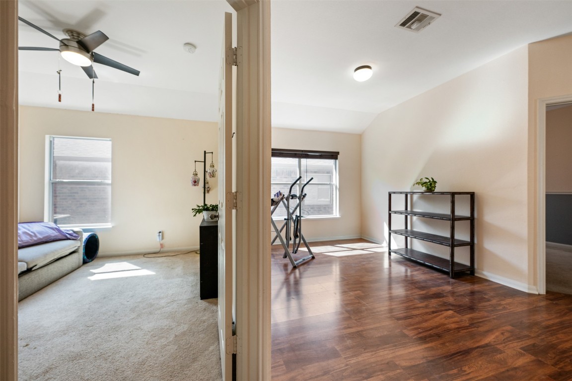 221 Stone Crest Boulevard Buda, TX 78610 - Photo 29 of 33 a living room with furniture and a wooden floor
