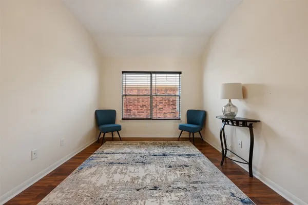 a view of a livingroom with wooden floor and a window