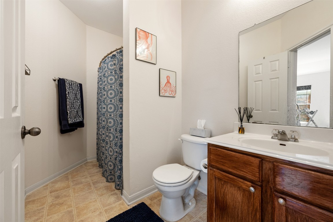 221 Stone Crest Boulevard Buda, TX 78610 - Photo 31 of 33 a bathroom with a sink a toilet and shower