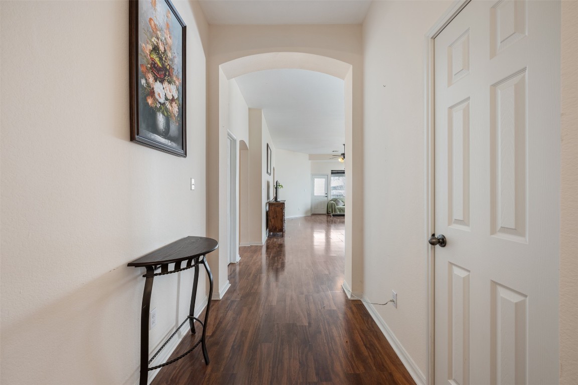221 Stone Crest Boulevard Buda, TX 78610 - Photo 4 of 33 a view of a hallway with wooden floor and staircase