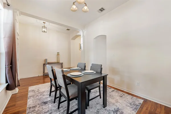 a view of a dining room with furniture and wooden floor