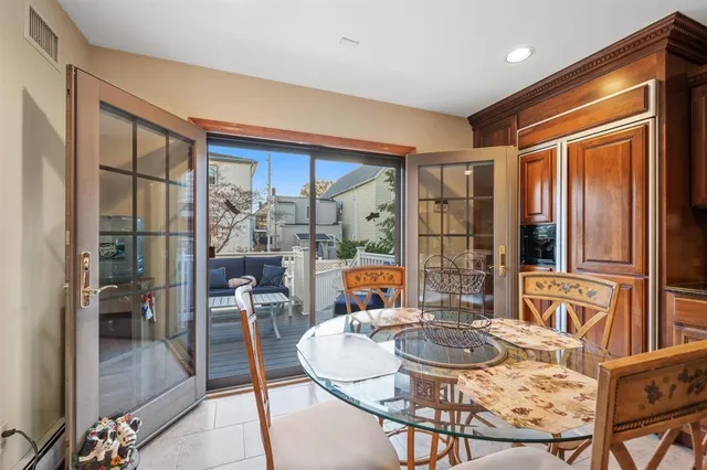a dining room with furniture a livingroom view and large windows