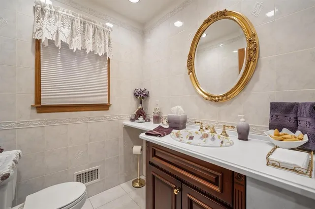 a bathroom with a toilet a sink and a mirror