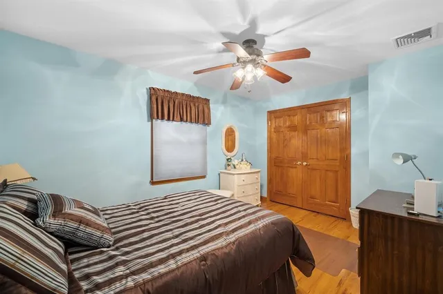 a bedroom with a large bed and a chandelier