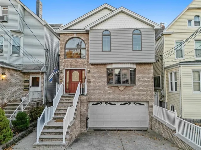 a view of a white house with large windows and a table
