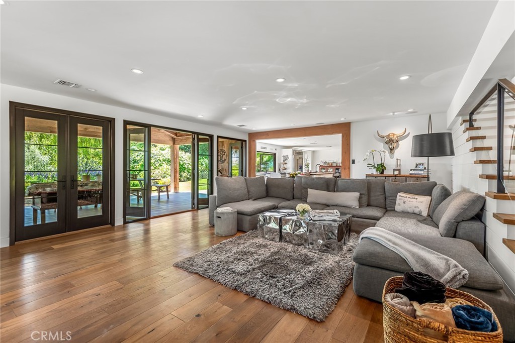 5207 Saddle Creek Road Hidden Hills, CA 91302 - Photo 13 of 54 a living room with furniture and a floor to ceiling window