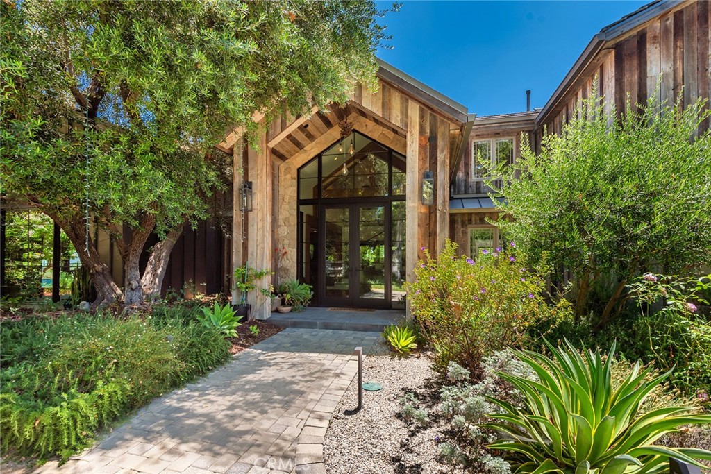 5207 Saddle Creek Road Hidden Hills, CA 91302 - Photo 2 of 54 a front view of a house with garden