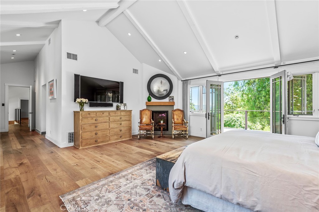 5207 Saddle Creek Road Hidden Hills, CA 91302 - Photo 22 of 54 a spacious bedroom with a bed and a flat screen tv