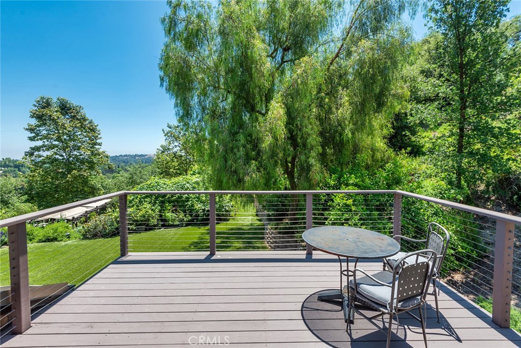 5207 Saddle Creek Road Hidden Hills, CA 91302 - Photo 29 of 54 a view of a chair and tables on the deck