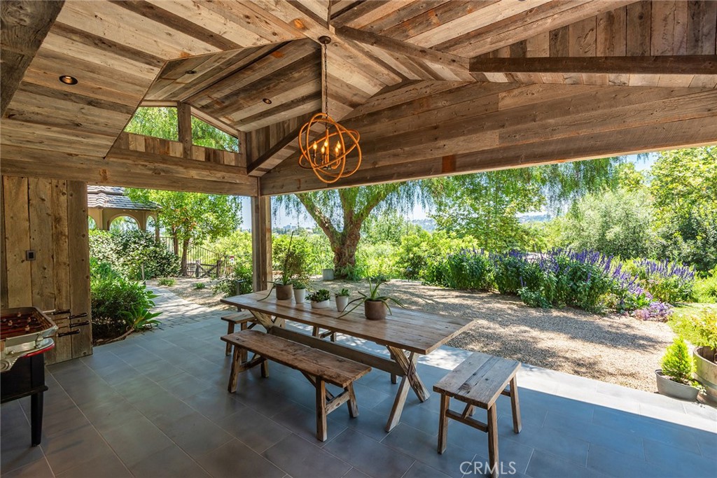 5207 Saddle Creek Road Hidden Hills, CA 91302 - Photo 33 of 54 a backyard of a house with table and chairs