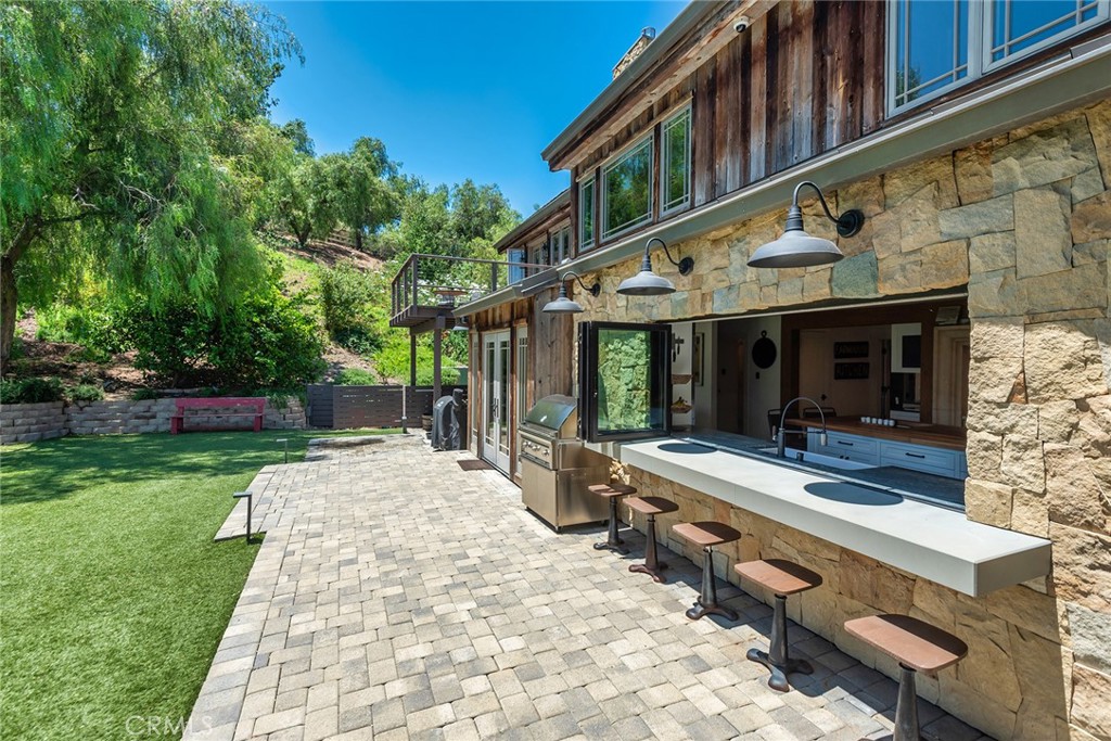 5207 Saddle Creek Road Hidden Hills, CA 91302 - Photo 34 of 54 a view of house with outdoor seating area