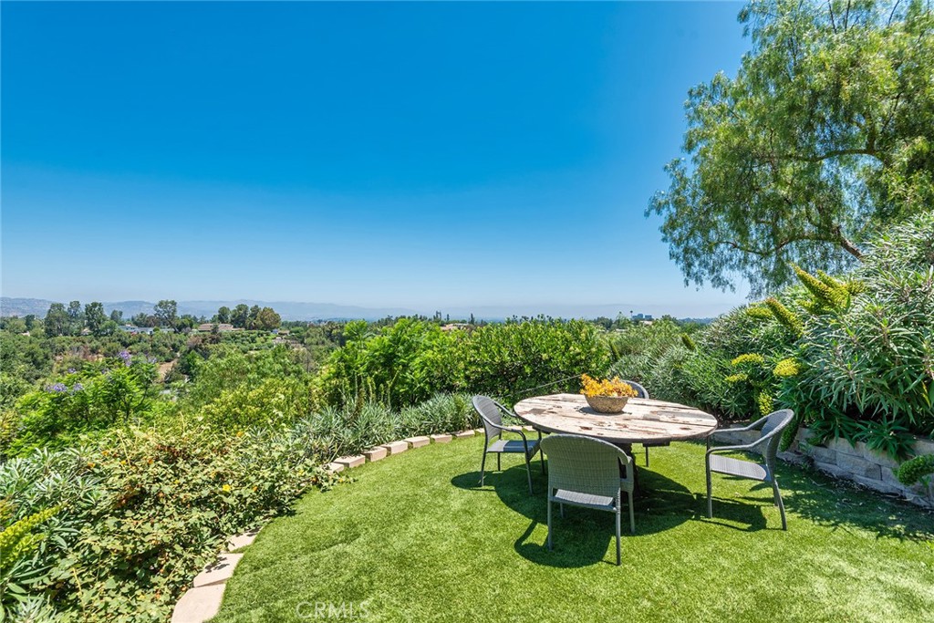 5207 Saddle Creek Road Hidden Hills, CA 91302 - Photo 44 of 54 a backyard of a house with table and chairs