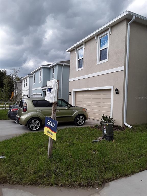 a car parked in front of a house and a yard