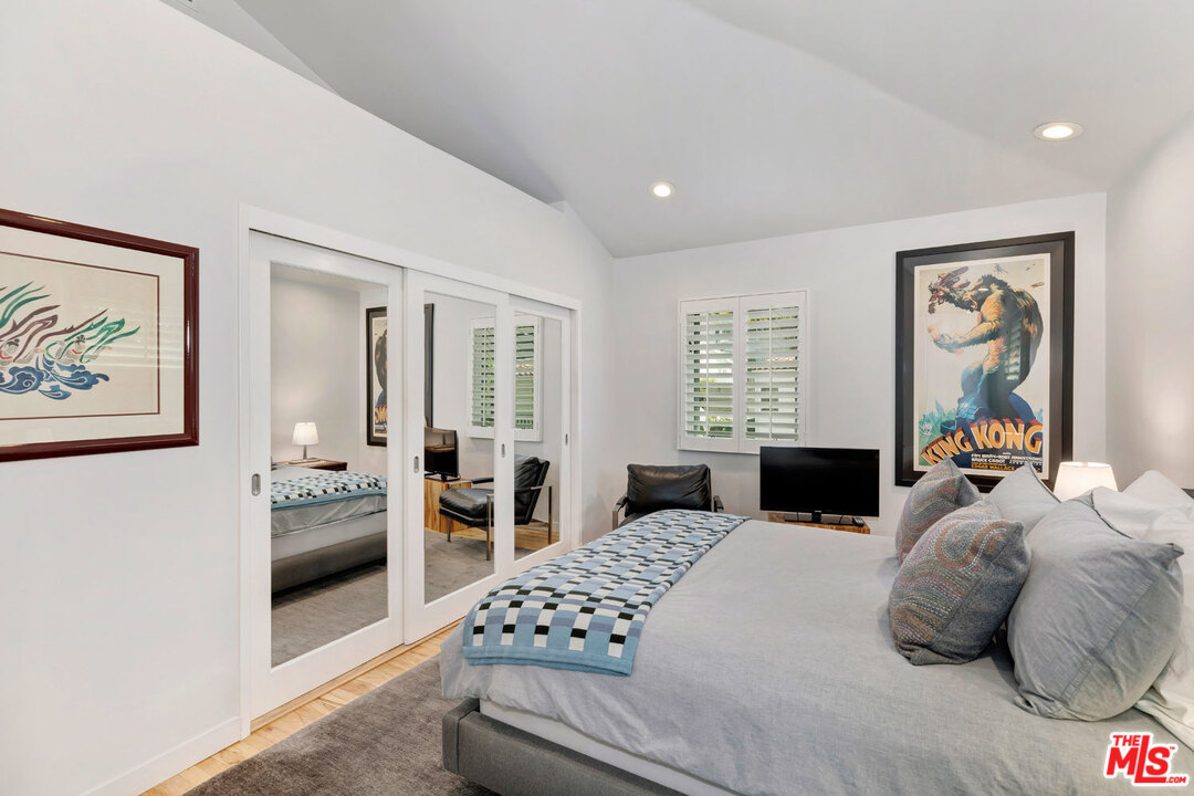 9831 Easton Drive Beverly Hills, CA 90210 - Photo 17 of 27 a bedroom with a large bed and a window