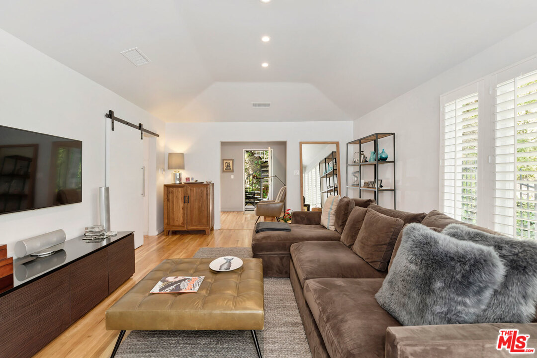 9831 Easton Drive Beverly Hills, CA 90210 - Photo 4 of 27 a living room with furniture and a flat screen tv