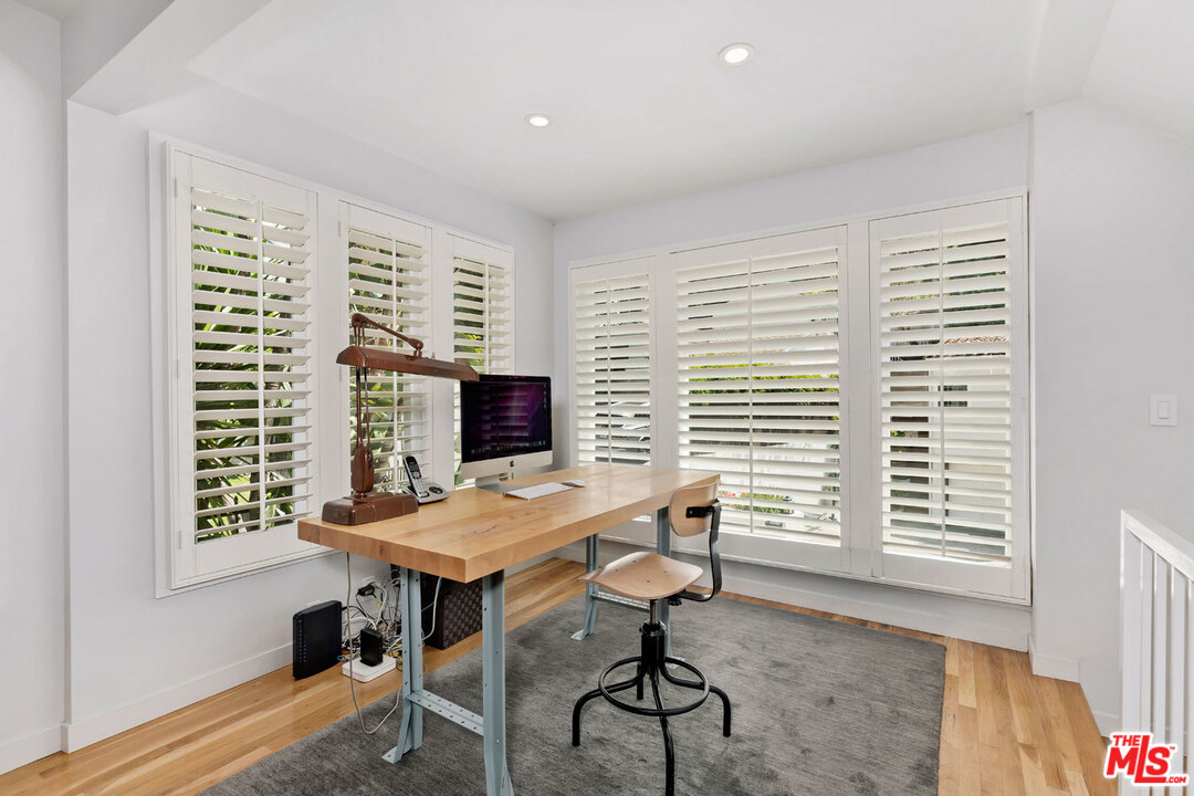 9831 Easton Drive Beverly Hills, CA 90210 - Photo 6 of 27 a view of a workspace with furniture and a window