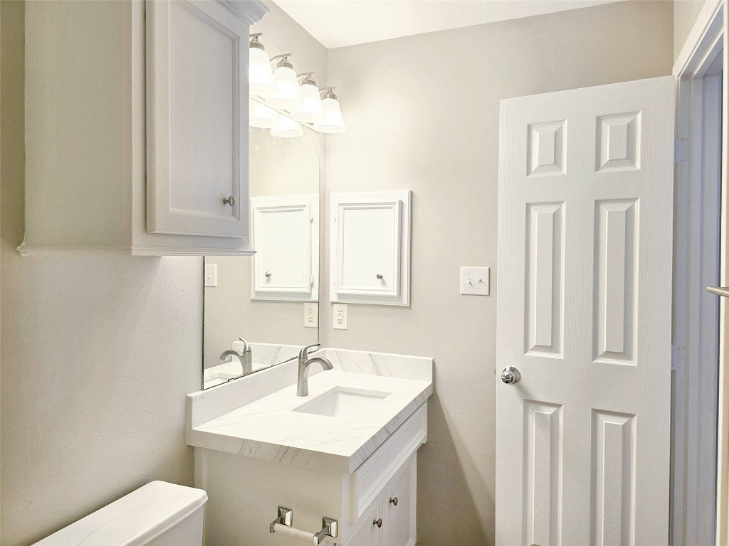 2211 Runnels Street Houston, TX 77003 - Photo 11 of 17 a bathroom with a sink a toilet and a mirror