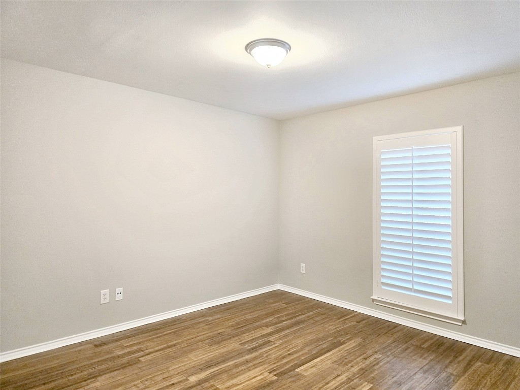 2211 Runnels Street Houston, TX 77003 - Photo 13 of 17 a view of an empty room with wooden floor and a window