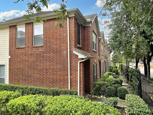 a view of a house with a yard and plants