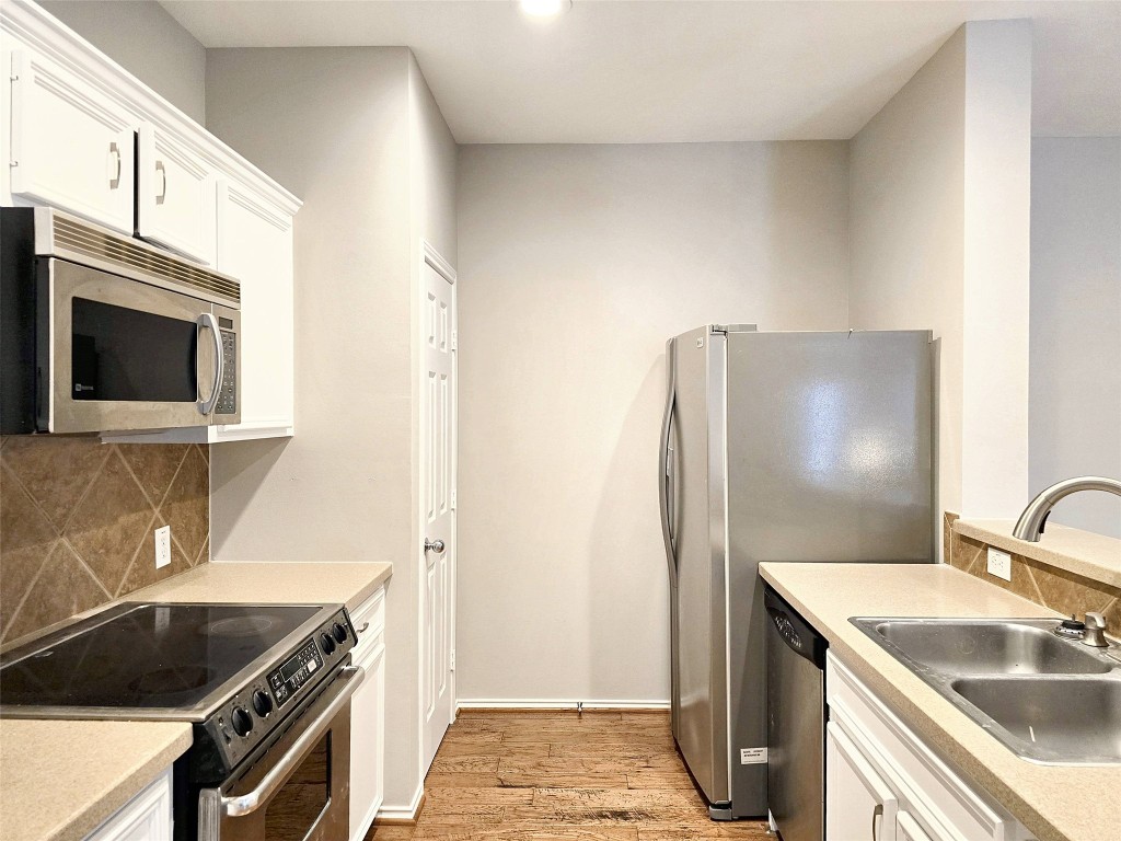 2211 Runnels Street Houston, TX 77003 - Photo 7 of 17 a kitchen with stainless steel appliances granite countertop a sink stove and refrigerator