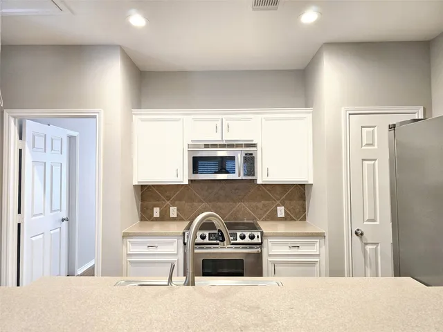 a view of kitchen and refrigerator