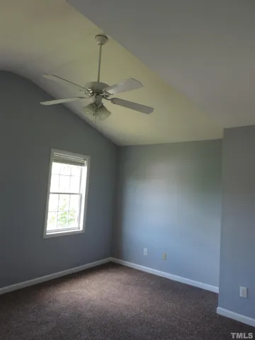 a view of room with window and ceiling fan