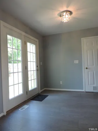 an empty room with a empty space and a window