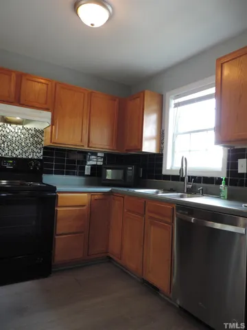 a kitchen with stainless steel appliances granite countertop a stove and a sink